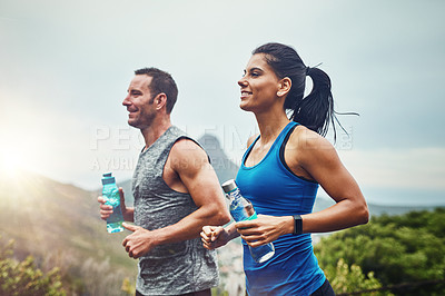 Buy stock photo Energy, running and couple in nature for exercise with water bottle, fitness adventure and training for sport competition. Runner team, man and woman for outdoor workout cardio and marathon challenge