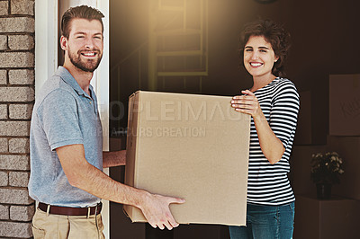 Buy stock photo Shot of a delivery man making a delivery to a customer at her home