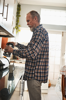 Buy stock photo Morning, senior man and making coffee in kitchen in home for drink, energy or health. Retirement, person and preparing cup of tea, espresso and latte beverage refreshment with jar to relax in house