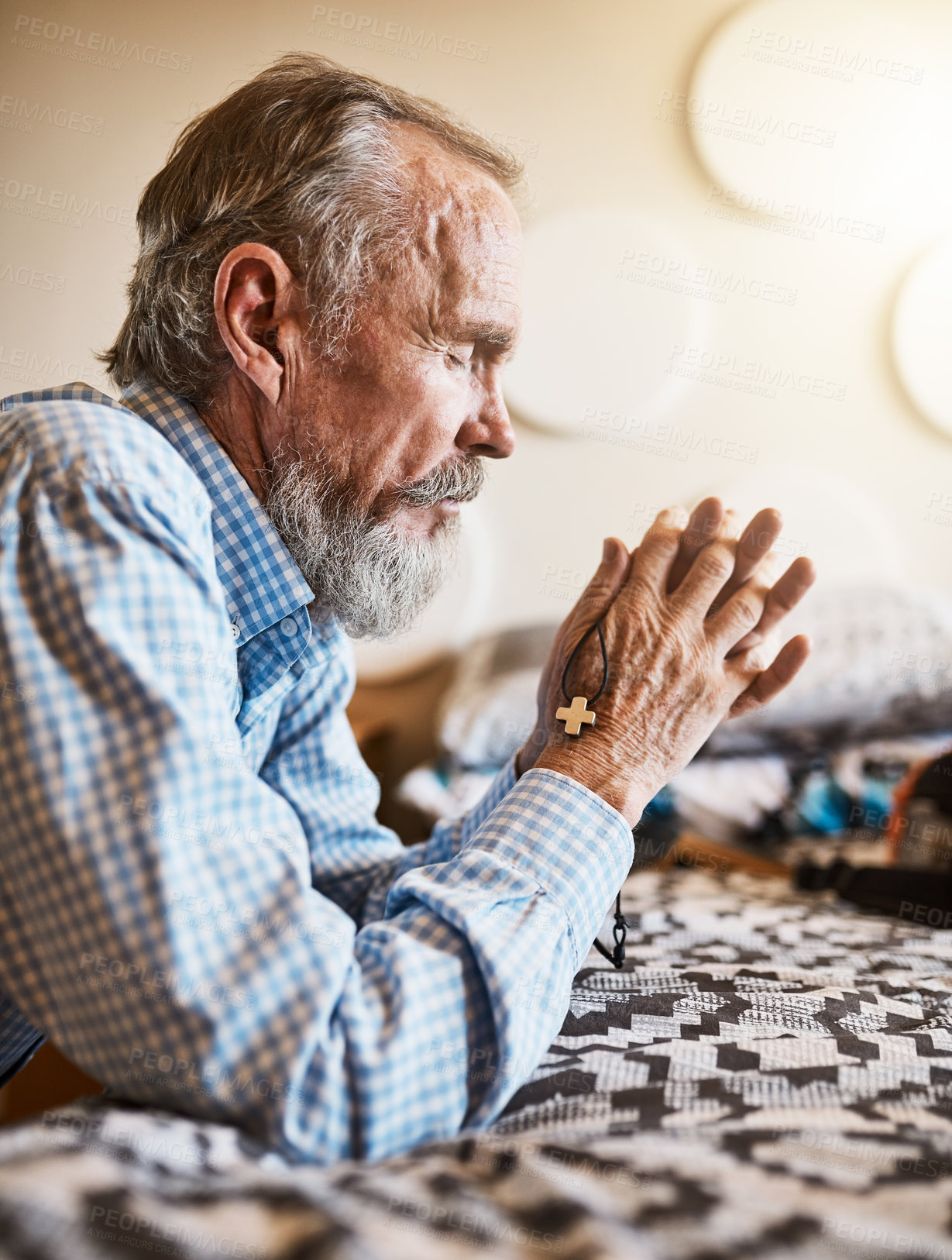 Buy stock photo Cross, faith and praying with old man in bedroom of home for Christian praise or worship to God. Confession, crucifix and profile of elderly person talking to Jesus on bed for Catholic belief