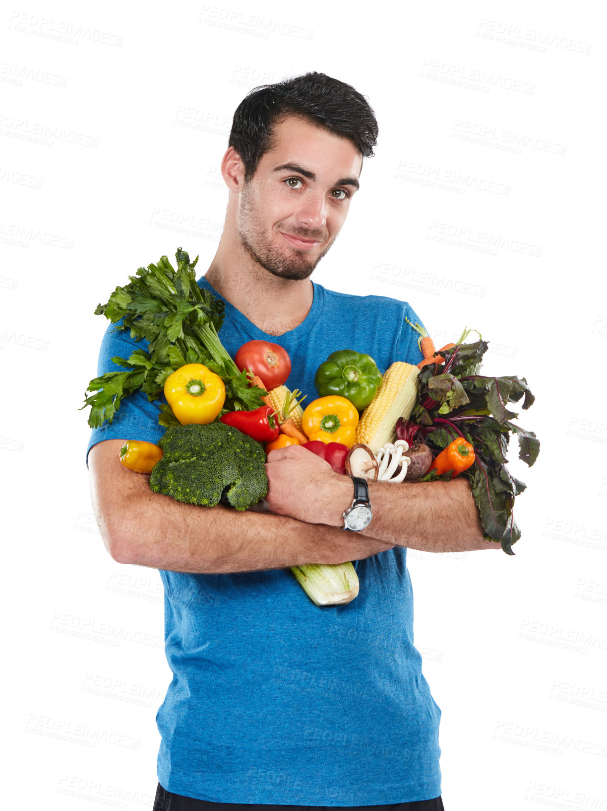 Buy stock photo Studio portrait of a handsome young man posing with a variety of fresh vegetables against a white background