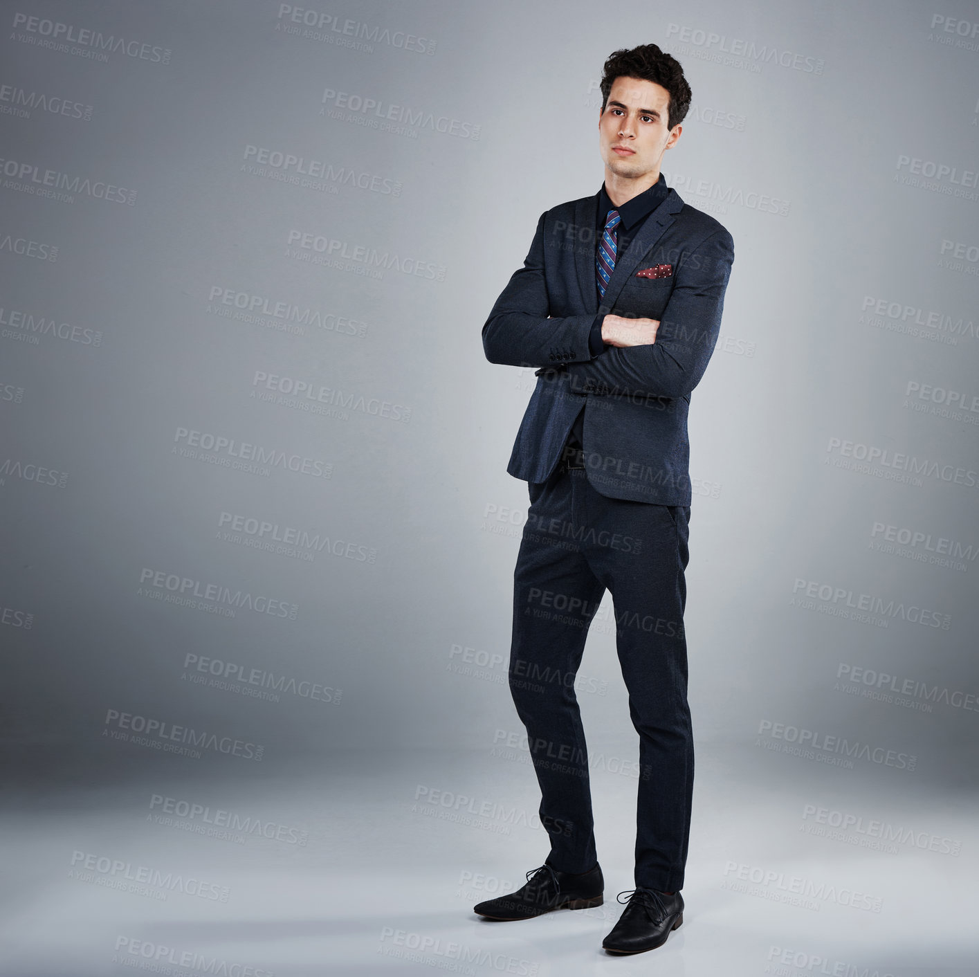 Buy stock photo Studio shot of a young businessman against a grey background