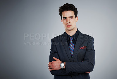 Buy stock photo Studio shot of a young businessman against a grey background