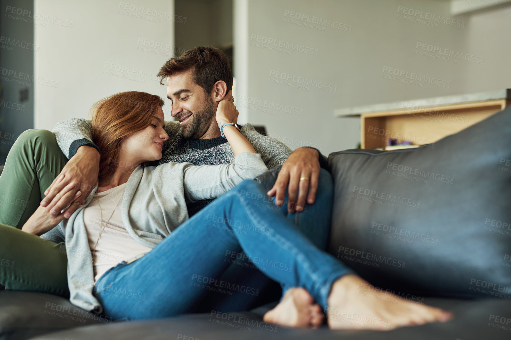 Buy stock photo Couple, happy and relax on sofa at house for comfort, love and bonding time together with trust and care. Man, woman and holding hands in living room for connection, peace and support on weekend 