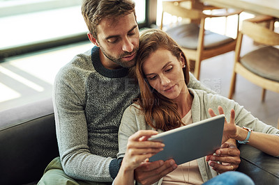 Buy stock photo Couple, hug and tablet on sofa for streaming subscription, movie selection or tv decision at home. Smile, man and woman with technology and web search on couch for bonding, scroll and show discussion