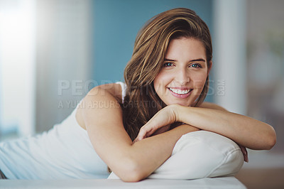 Buy stock photo Cropped shot of a young woman relaxing on her sofa at home