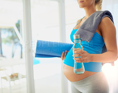 Buy stock photo Cropped shot of a pregnant woman getting ready to workout at home