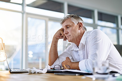 Buy stock photo Shot of a mature businessman falling asleep at his desk in the office