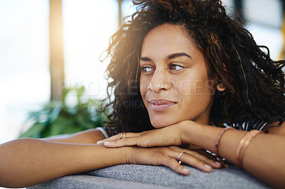 Buy stock photo Shot of an attractive young woman relaxing at home on the weekend