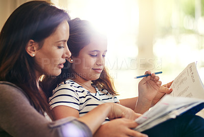 Buy stock photo Shot of a beautiful mother and her adorable daughter bonding at home