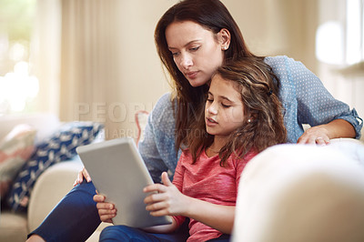 Buy stock photo Shot of a beautiful mother and her adorable daughter bonding at home