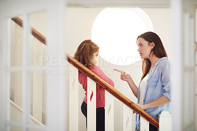 Buy stock photo Shot of a mother disciplining her young daughter at home