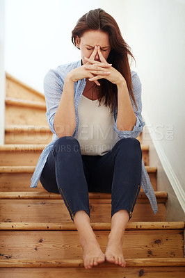 Buy stock photo Shot of a young woman looking stressed out at home
