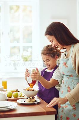 Buy stock photo Shot of a mother and daughter preparing food in the kitchen at home