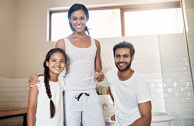 Buy stock photo Portrait of parents showing their little daughter a pregnancy test stick at home
