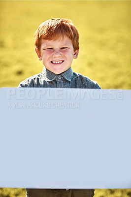 Buy stock photo Portrait of a little boy holding a blank board outdoors