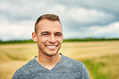 Buy stock photo Portrait of a young man standing outdoors