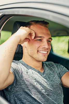 Buy stock photo Shot of a young man driving a car