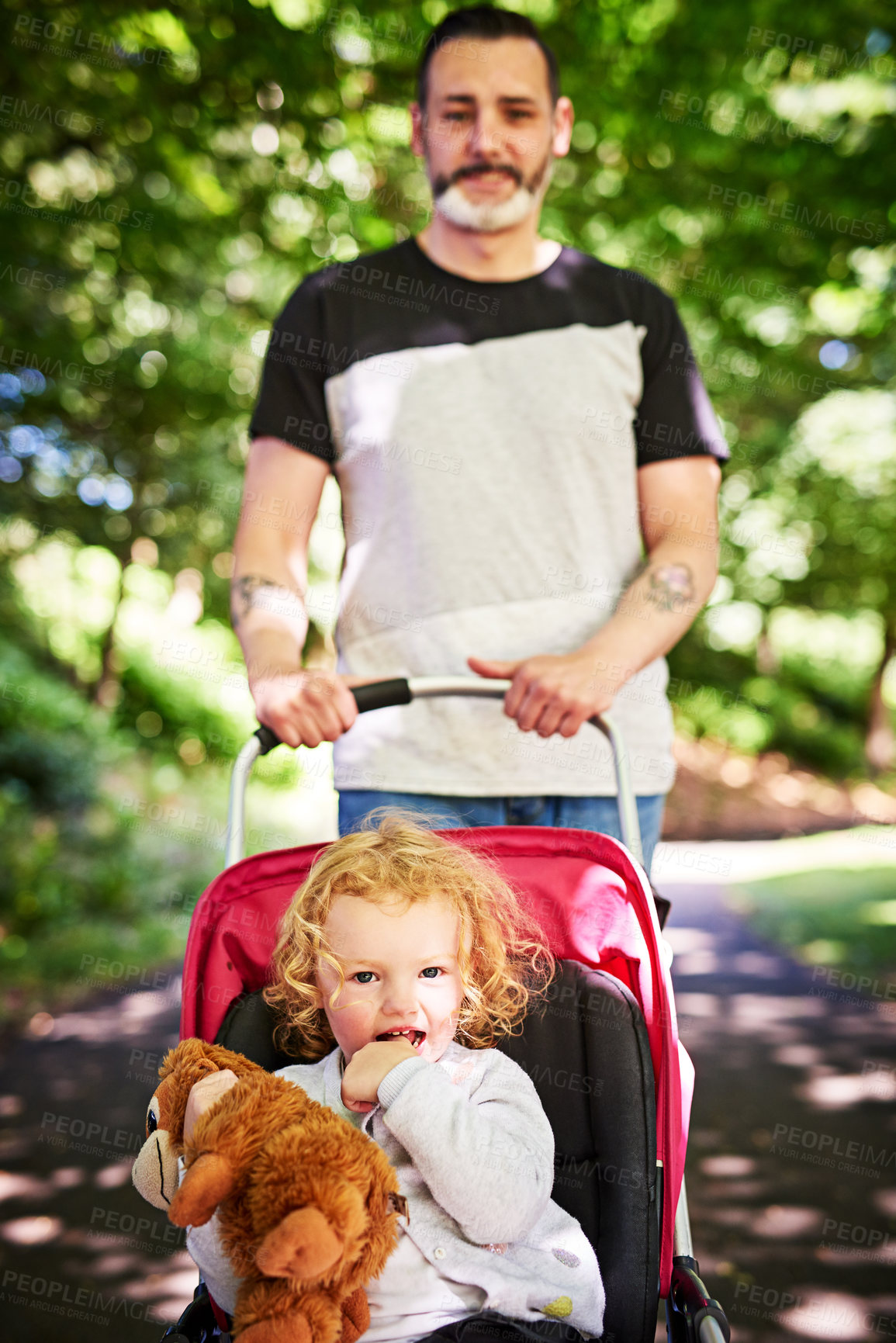 Buy stock photo Portrait of a father pushing his little daughter in a stroller outdoors