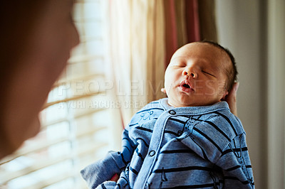 Buy stock photo Shot of a tired little baby boy sleeping with his  eyes closed while his mother holds him in her hands at home