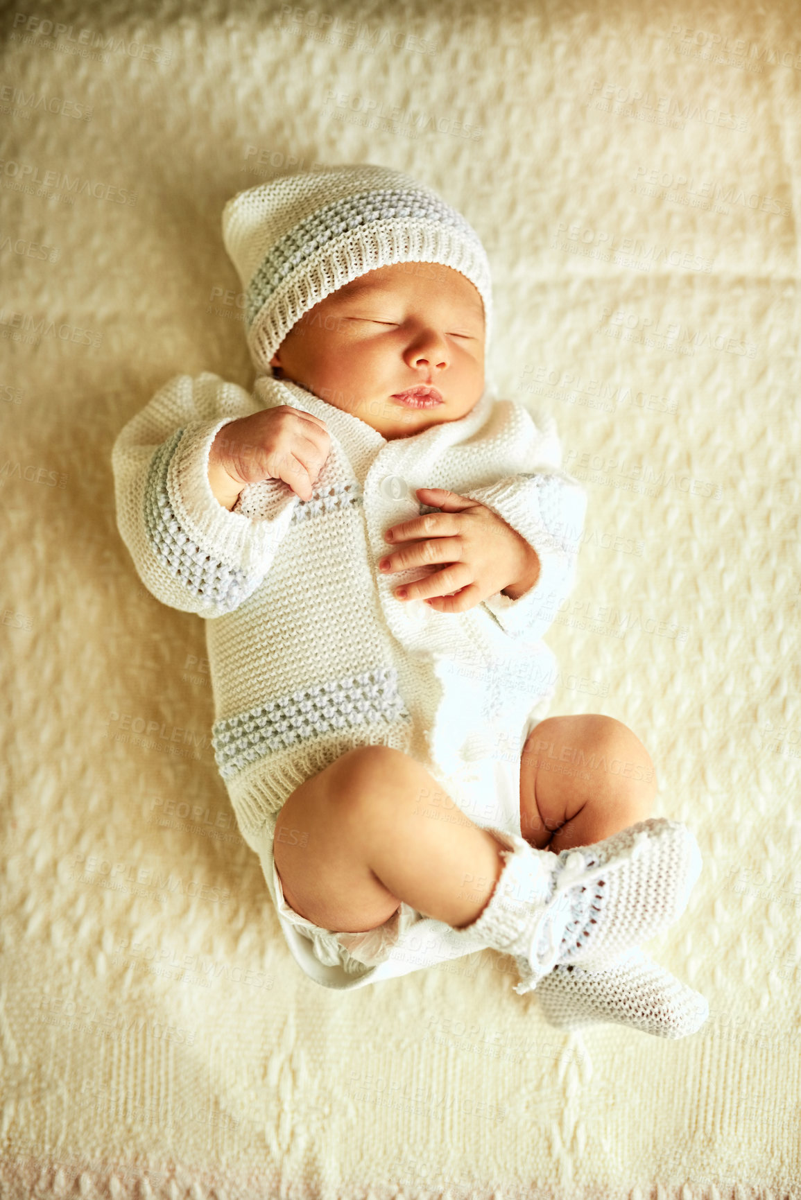 Buy stock photo Shot of a tired little baby boy sleeping with his eyes closed on a bed at home