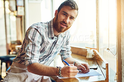 Buy stock photo Coffee shop, writing and portrait of man with documents for menu items, stock and product inventory. Restaurant, cafe and business owner with paperwork for planning, review and checklist by counter