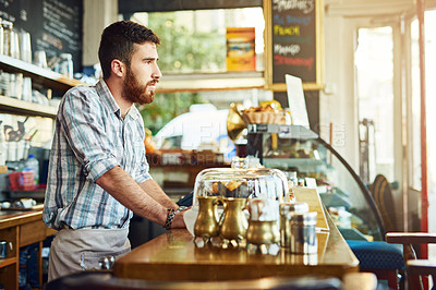 Buy stock photo Cropped shot of a young man working in a coffee shop