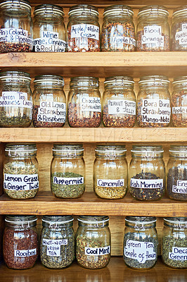 Buy stock photo Container, tea jar and shelf at coffee shop for catering, flavor or organic leaves for drink in closeup. Glass, antioxidant and natural herbs with stock, inventory or label for beverage at cafeteria