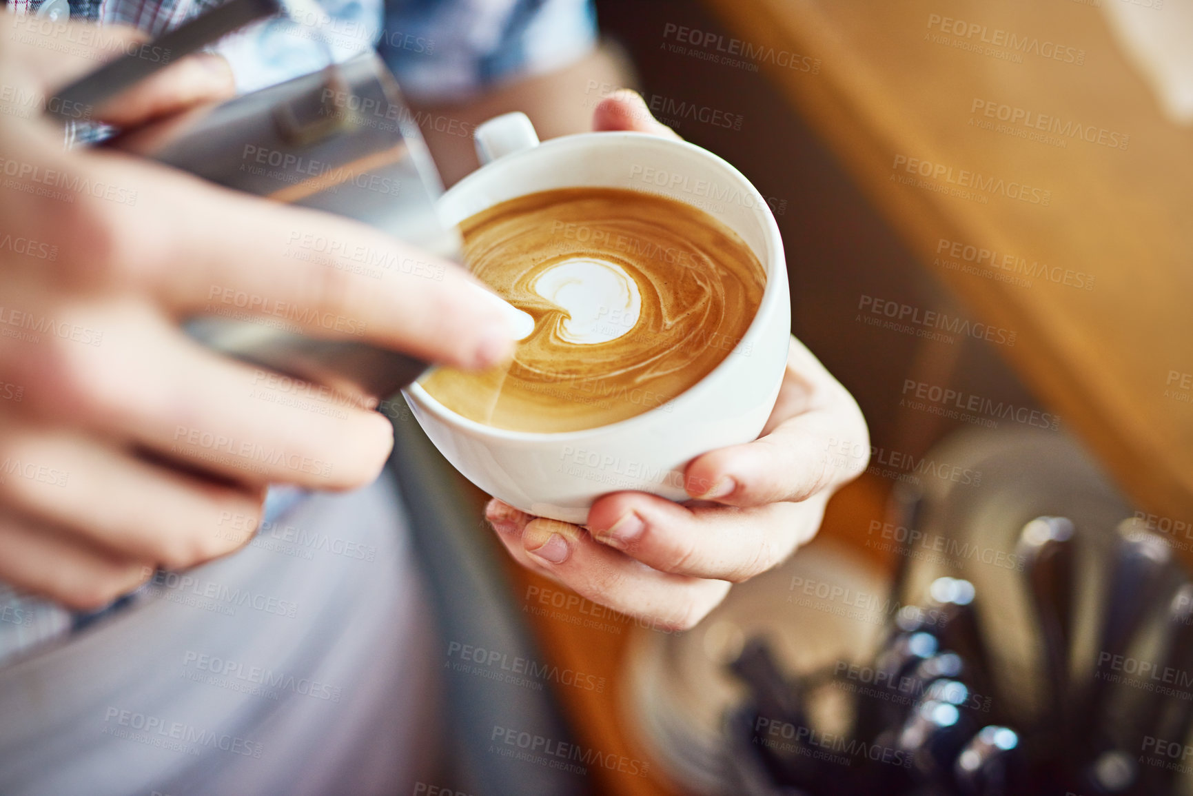 Buy stock photo Barista, hands and milk design in coffee at cafe, espresso and server for liquid art hospitality. Person, professional and shape in beverage at bistro, latte production and process for pattern in cup