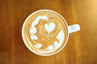 Buy stock photo Above, cream and coffee with art, wooden table or caffeine with creativity, skill or cup. Top view, mug or cappuccino with heart, symbol for love or kindness in restaurant, friendly service or option