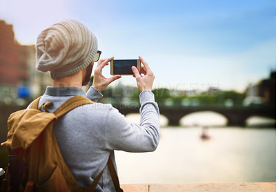 Buy stock photo Man, phone and photography in city for tourism, social media and travel with backpack on holiday. Male person, mobile and picture of urban town for adventure, memory and trip with bridge on vacation