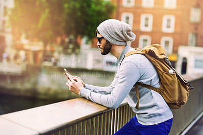 Buy stock photo City, travel and man with phone on balcony for network, communication and search of location. Internet, male person and backpack with technology for outdoor commute, information and tourism in London