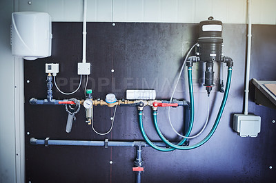 Buy stock photo Shot of equipment mounted against a wall in a factory