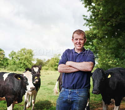 Buy stock photo Portrait of a male farmer standing with his arms folded on his dairy farm