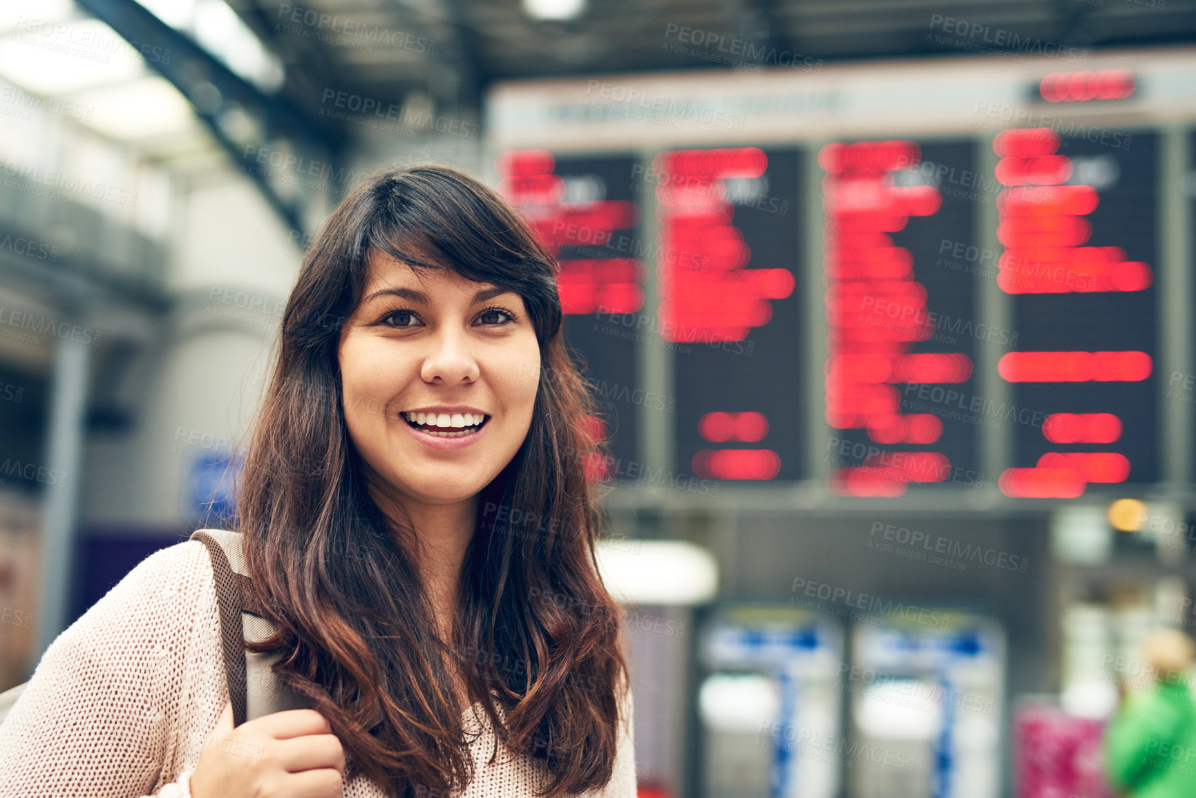 Buy stock photo Cropped portrait of an attractive young woman standing at an arrivals and departures board in the airport