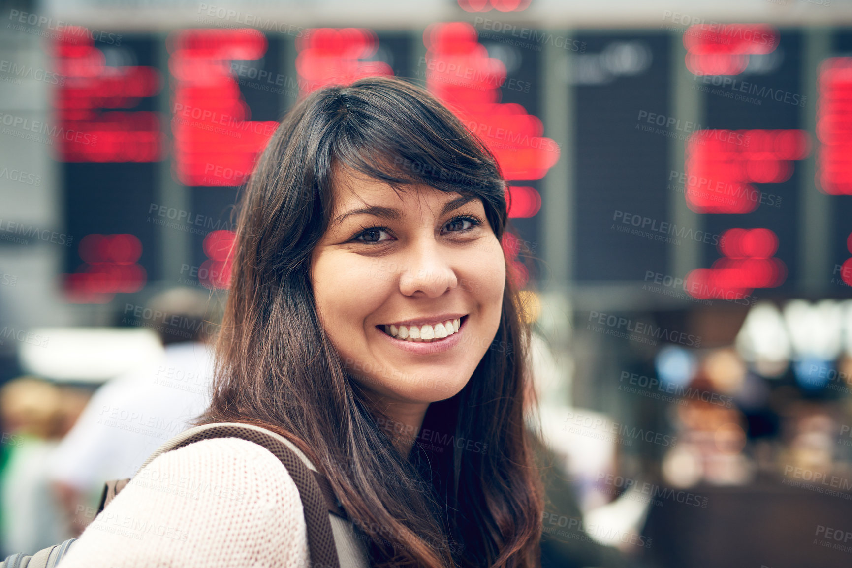 Buy stock photo Cropped portrait of an attractive young woman standing at an arrivals and departures board in the airport