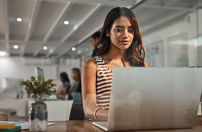Buy stock photo Cropped shot of an attractive young businesswoman working on her laptop in the office