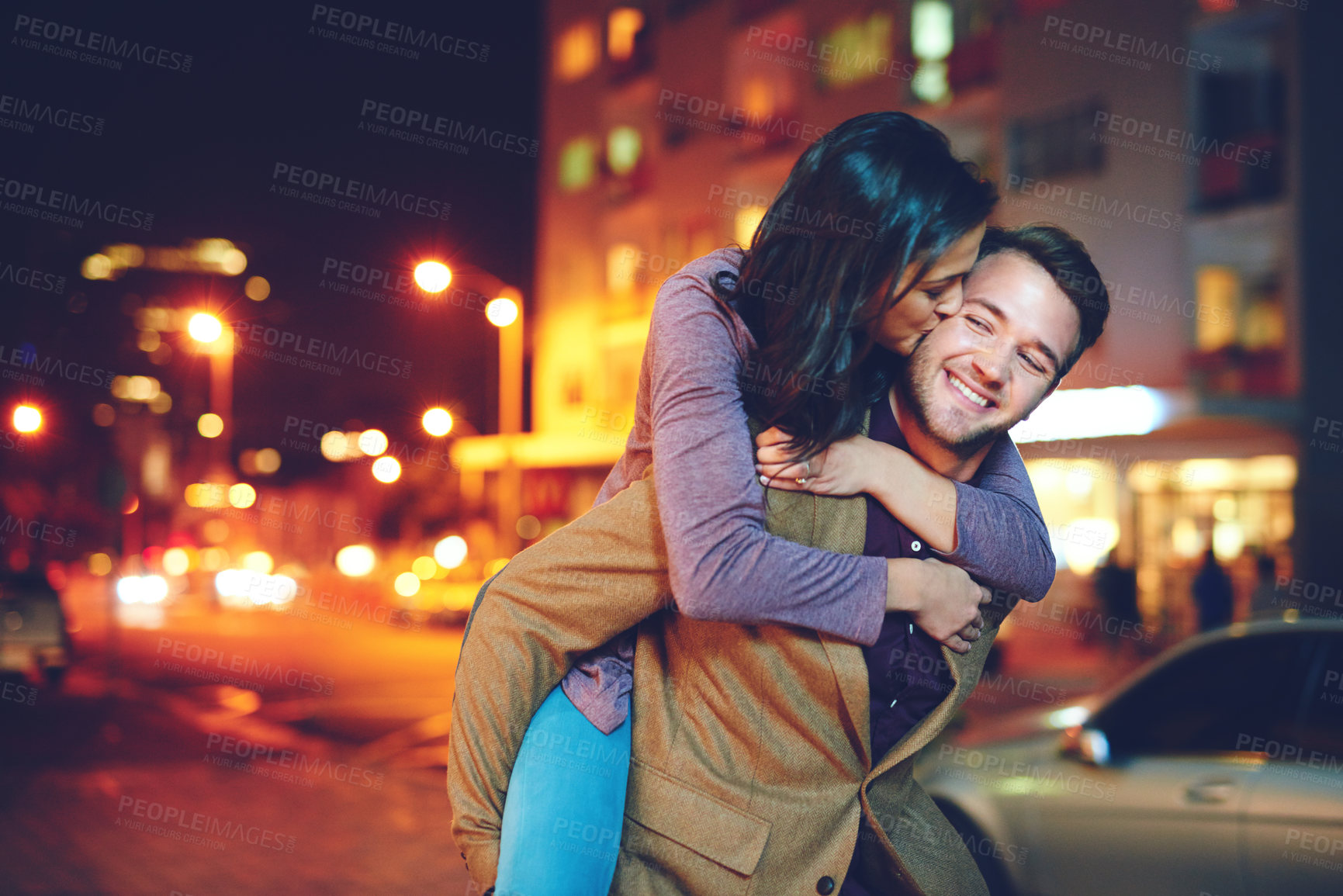 Buy stock photo Cropped shot of a handsome young man piggybacking his girlfriend while out on a date in the city