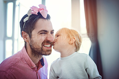 Buy stock photo Shot of an adorable little girl kissing her father on his cheek