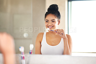 Buy stock photo Mirror, dental care and woman with toothbrush in bathroom for morning hygiene teeth routine. Smile, wellness and female person with oral health product for plaque, gums and fresh breath at home.