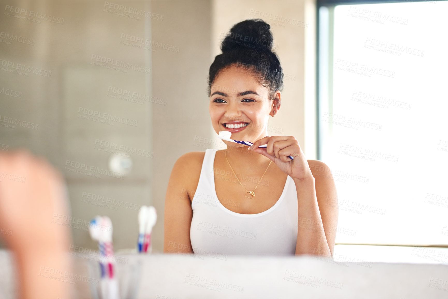 Buy stock photo Mirror, dental care and woman with toothbrush in bathroom for morning hygiene teeth routine. Smile, wellness and female person with oral health product for plaque, gums and fresh breath at home.