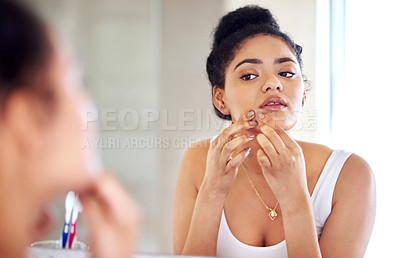 Buy stock photo Skincare, reflection and woman popping pimple on face with hands, dirt or scar on skin in home. Dermatology, facial wellness and girl in bathroom to squeeze acne, checking mirror or morning routine