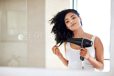 Buy stock photo Woman, bathroom and dryer tool for hair, hairstyle and electric appliance for haircare in home. Female person, grooming and heat treatment in routine, afro and reflection in mirror for cosmetics