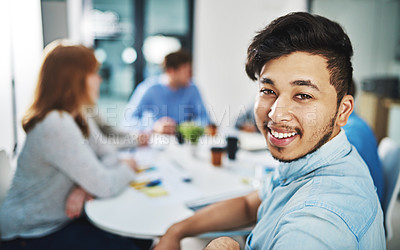 Buy stock photo Portrait of a young designer sitting in the boardroom with his colleagues