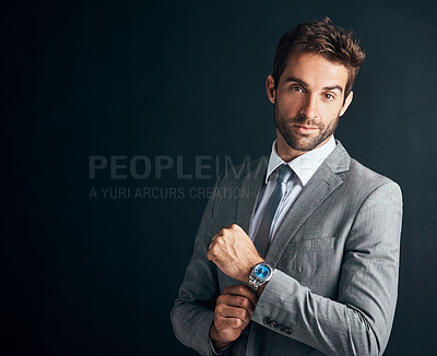 Buy stock photo Studio shot of a confident and stylishly dressed young businessman against a black background