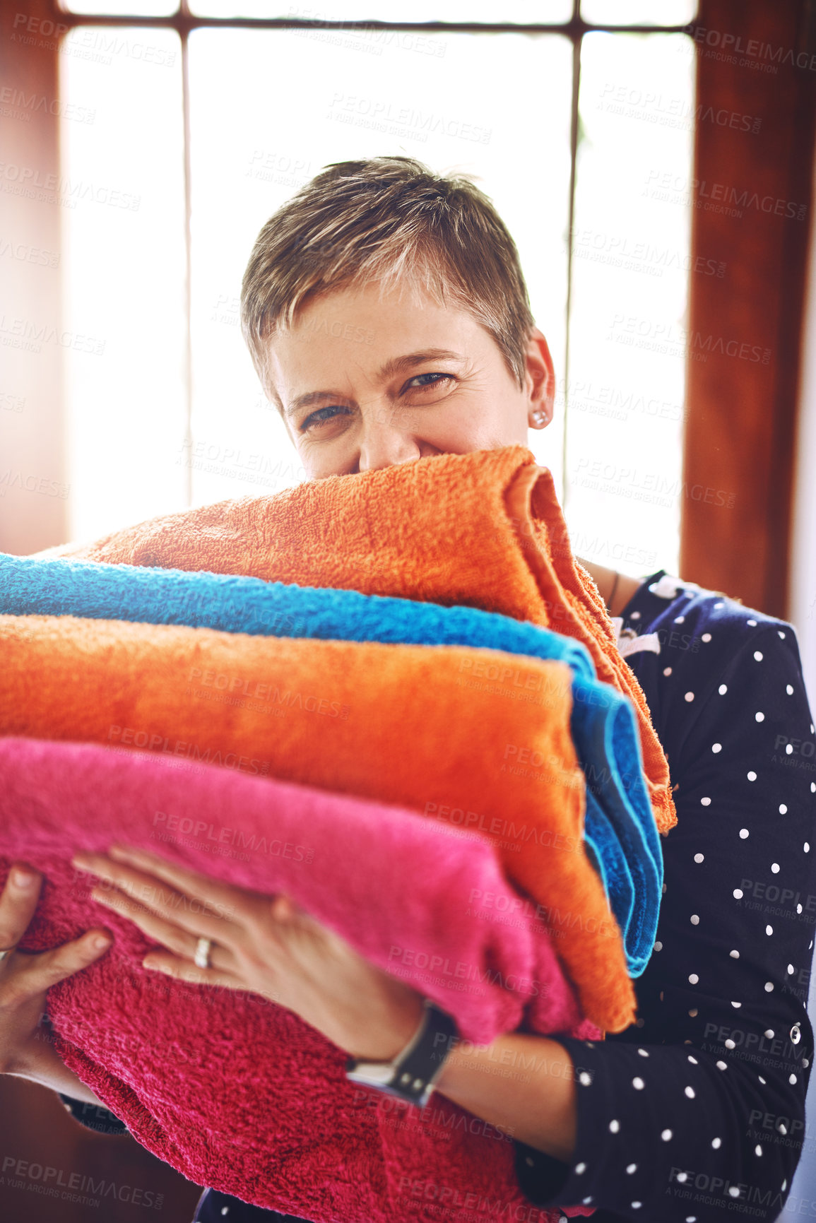 Buy stock photo Laundry, woman and clean towels in portrait after washing, housework and folded material in the morning. Home, housekeeping and cleaner or female person with color fabric or soft cloth as routine