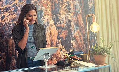 Buy stock photo Cropped shot of an attractive young woman working on a tablet behind the checkout counter in her store