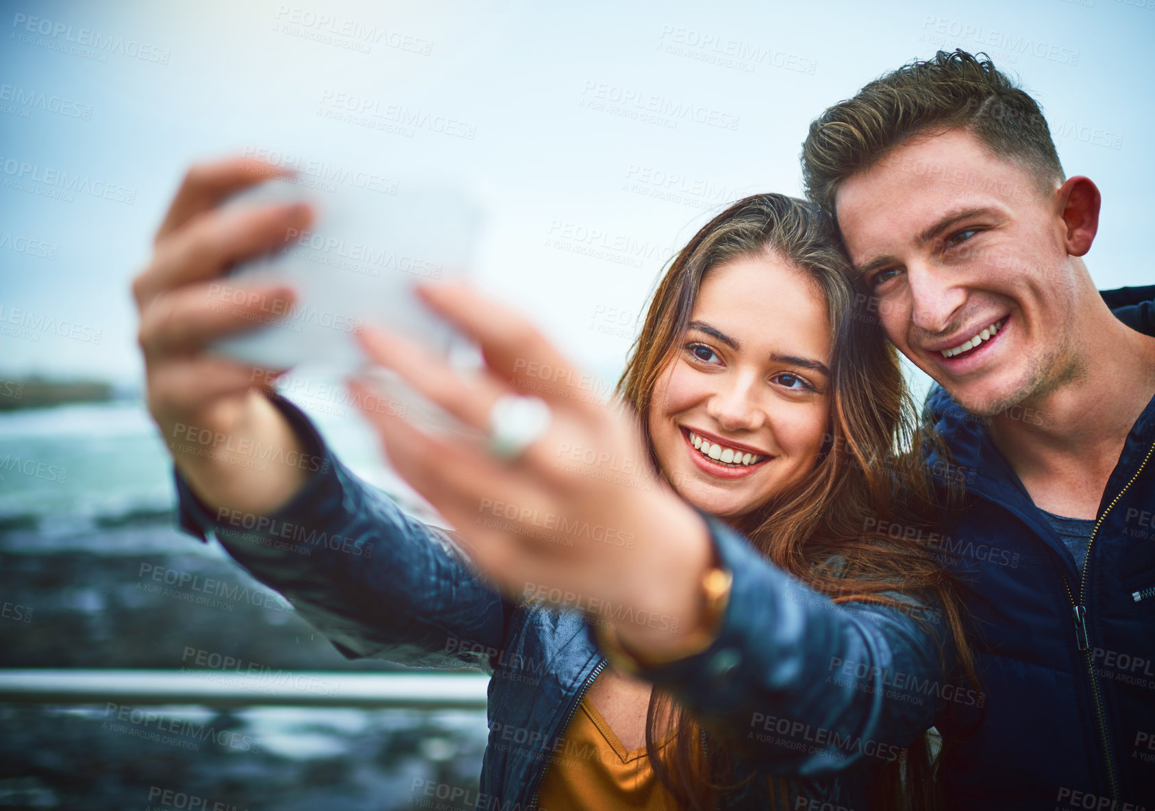 Buy stock photo Happy couple, beach and selfie with memory for moment, photography or relationship together in nature. Young, man and woman with smile for outdoor travel, picture or capture by ocean coast or sea