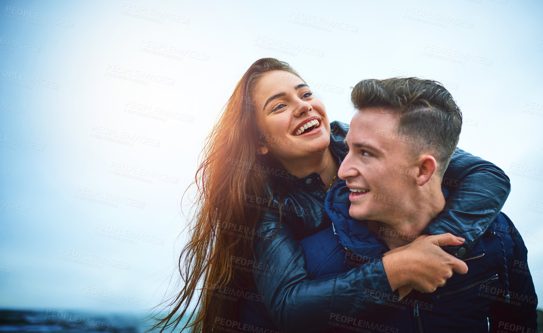 Buy stock photo Couple, hug and outdoor with laugh, love and piggy back on date with bonding and mockup. Happy, romance and gen z people together with travel and holiday in winter with support and care with fun