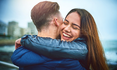 Buy stock photo Shot of a happy young couple embracing outdoors